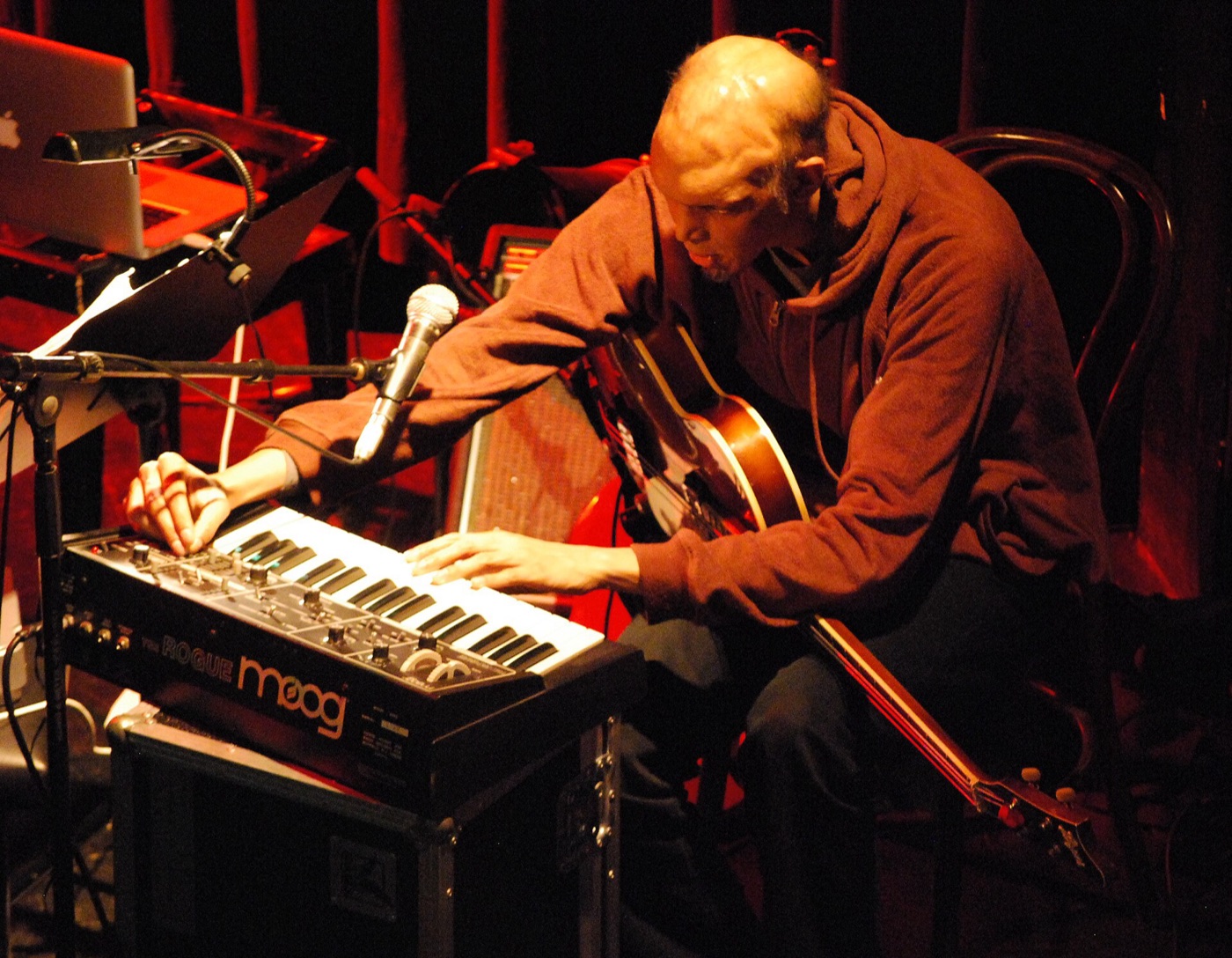 Shahzad Ismaily playing bass on stage, 2009.