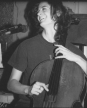 Leah Coloff at the cello, singing, in a black-and-white photograph from 2001.