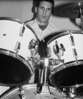 Mark Righter at the drums, in a black-and-white photograph from 2001.