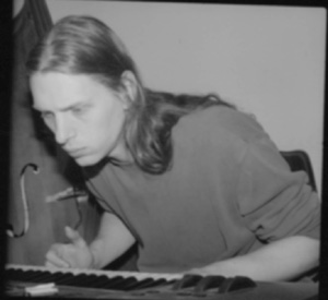Sarth Calhoun at a keyboard, an upright bass beside him, in a black-and-white photograph from 2001.