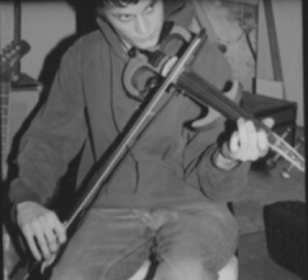 Tony Diodore playing violin, in a black-and-white photograph from 2001.